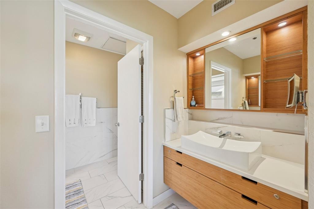 660 Cedars Court Longboat Key, FL 34228 - Photo 20 of 35 a bathroom with a shower sink and mirror