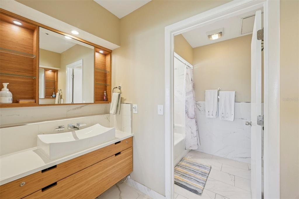 660 Cedars Court Longboat Key, FL 34228 - Photo 21 of 35 a bathroom with a sink and a mirror