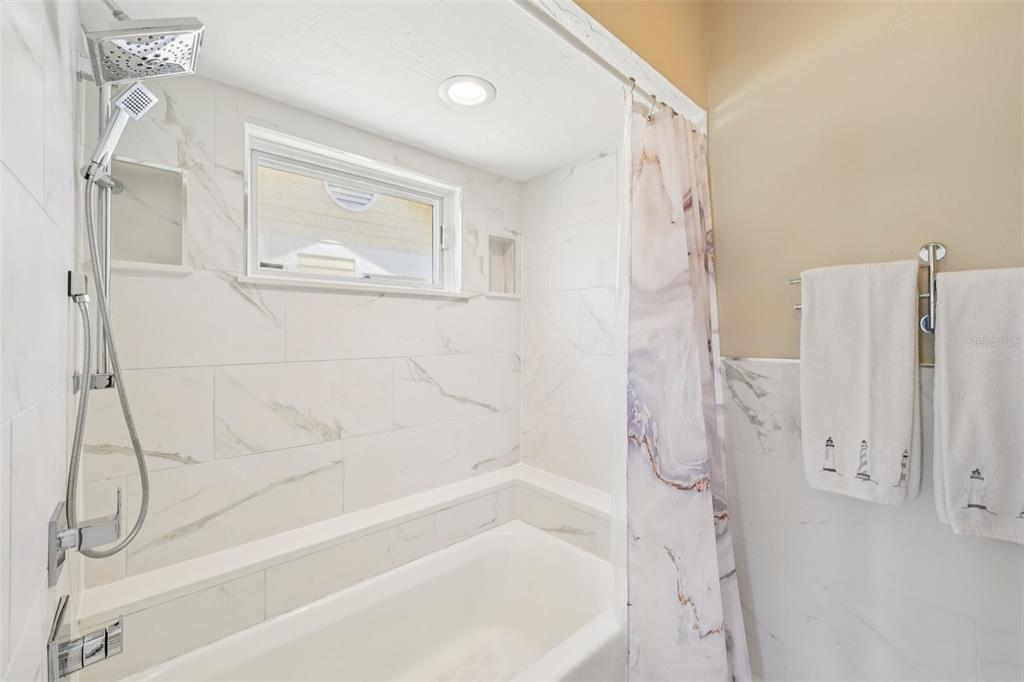 660 Cedars Court Longboat Key, FL 34228 - Photo 22 of 35 a bathroom with a bathtub and a shower
