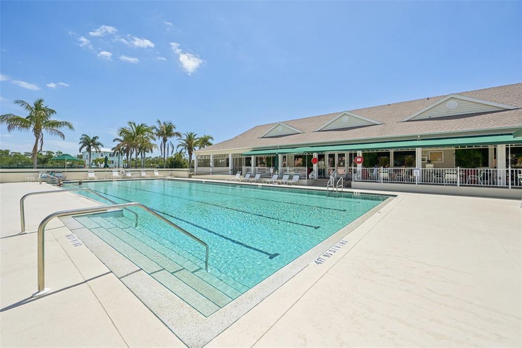 660 Cedars Court Longboat Key, FL 34228 - Photo 33 of 35 a view of a house with a swimming pool and sitting area