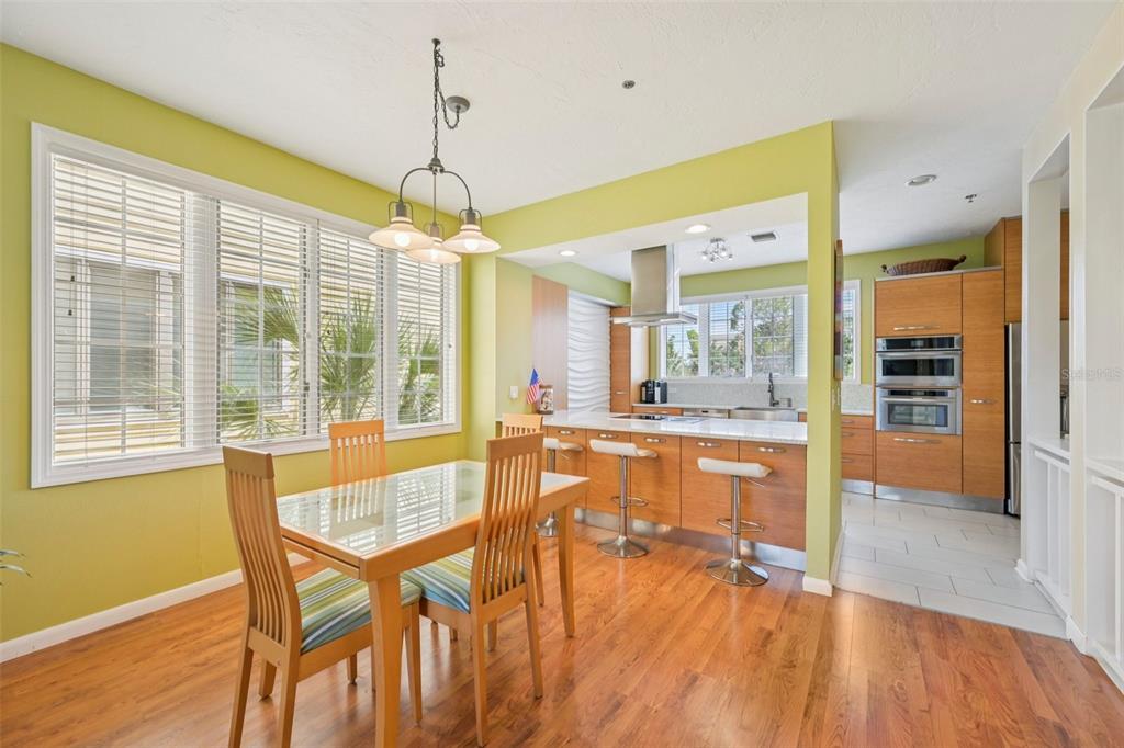 660 Cedars Court Longboat Key, FL 34228 - Photo 6 of 35 a dining room with stainless steel appliances granite countertop furniture a chandelier and wooden floor