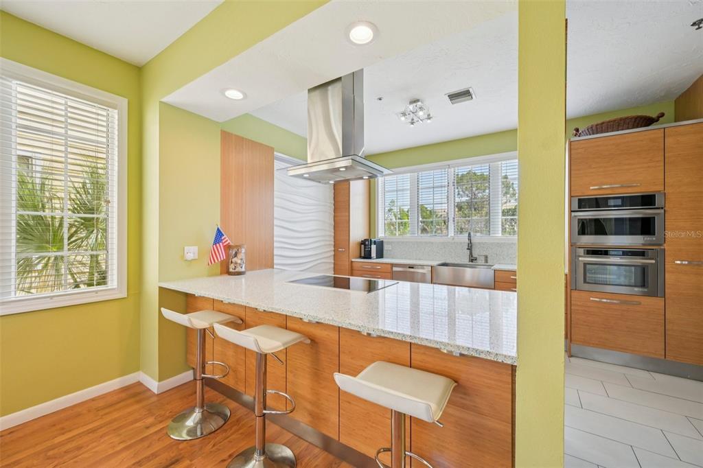 660 Cedars Court Longboat Key, FL 34228 - Photo 8 of 35 a kitchen with stainless steel appliances granite countertop a sink and a refrigerator