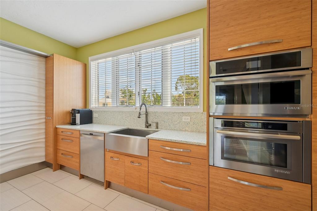 660 Cedars Court Longboat Key, FL 34228 - Photo 9 of 35 a kitchen with a stove microwave and cabinets