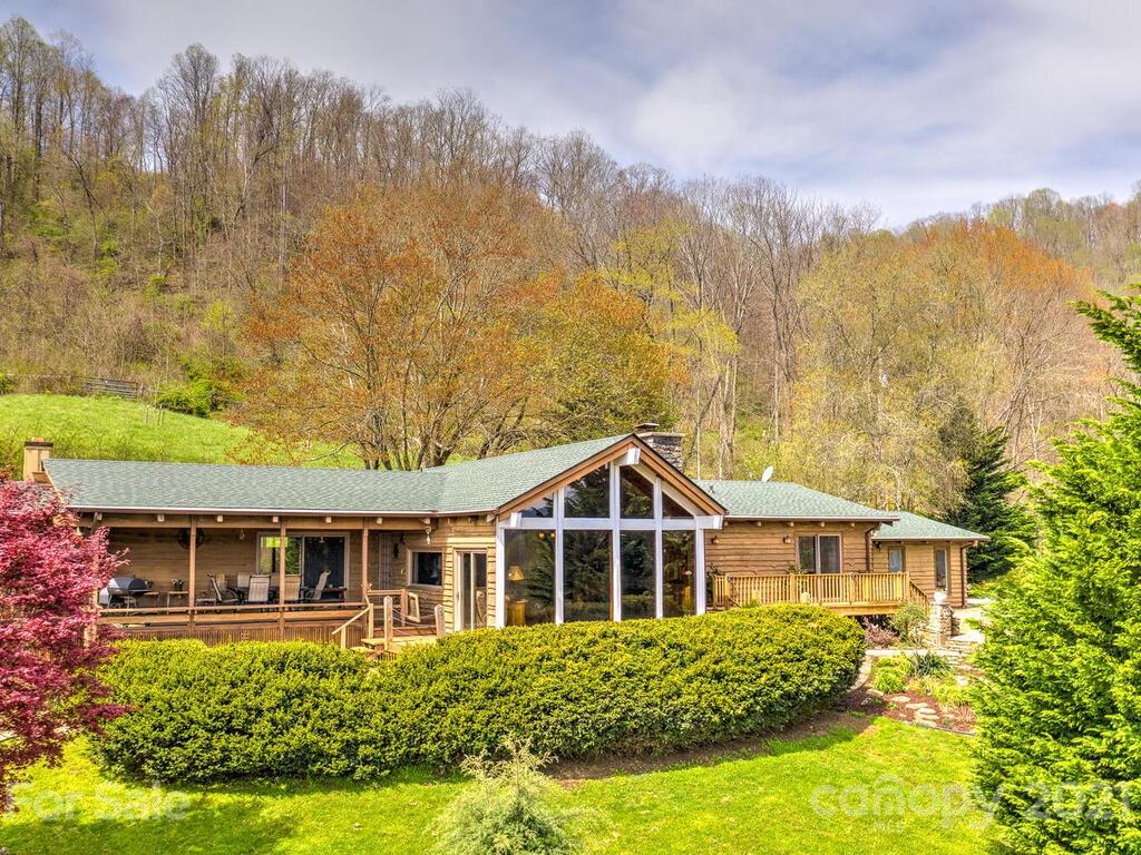 251 Riding High Road Waynesville, NC 28785 - Photo 1 of 41 a front view of a house with a yard and trees