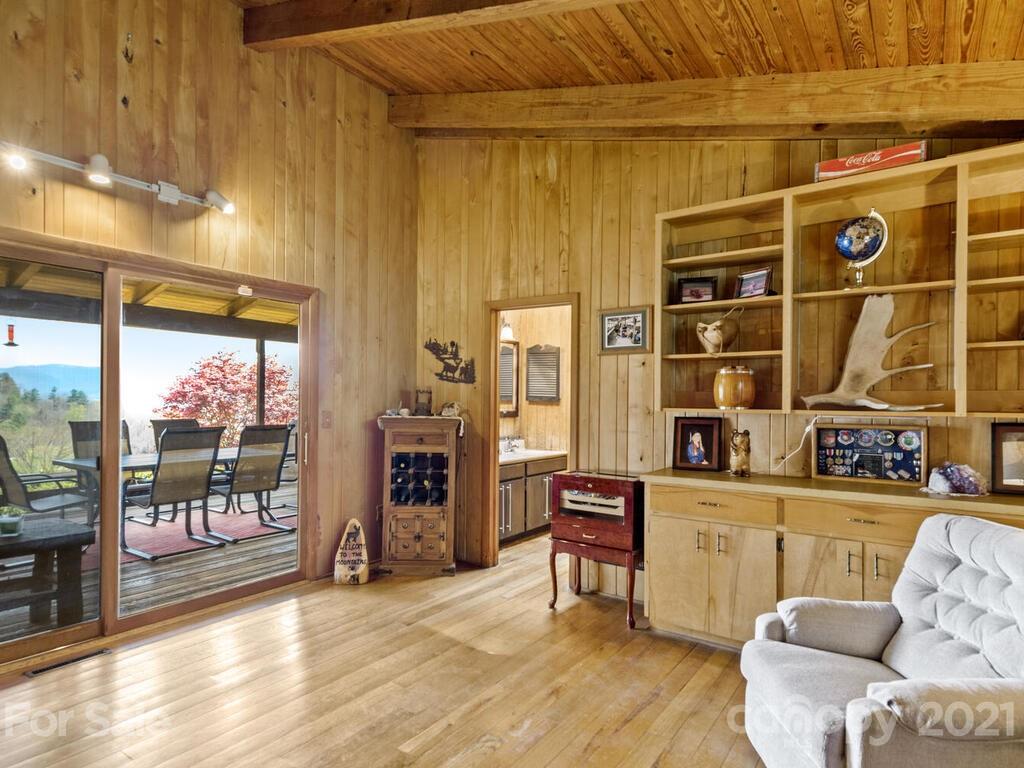 251 Riding High Road Waynesville, NC 28785 - Photo 14 of 41 a living room with furniture and a floor to ceiling window