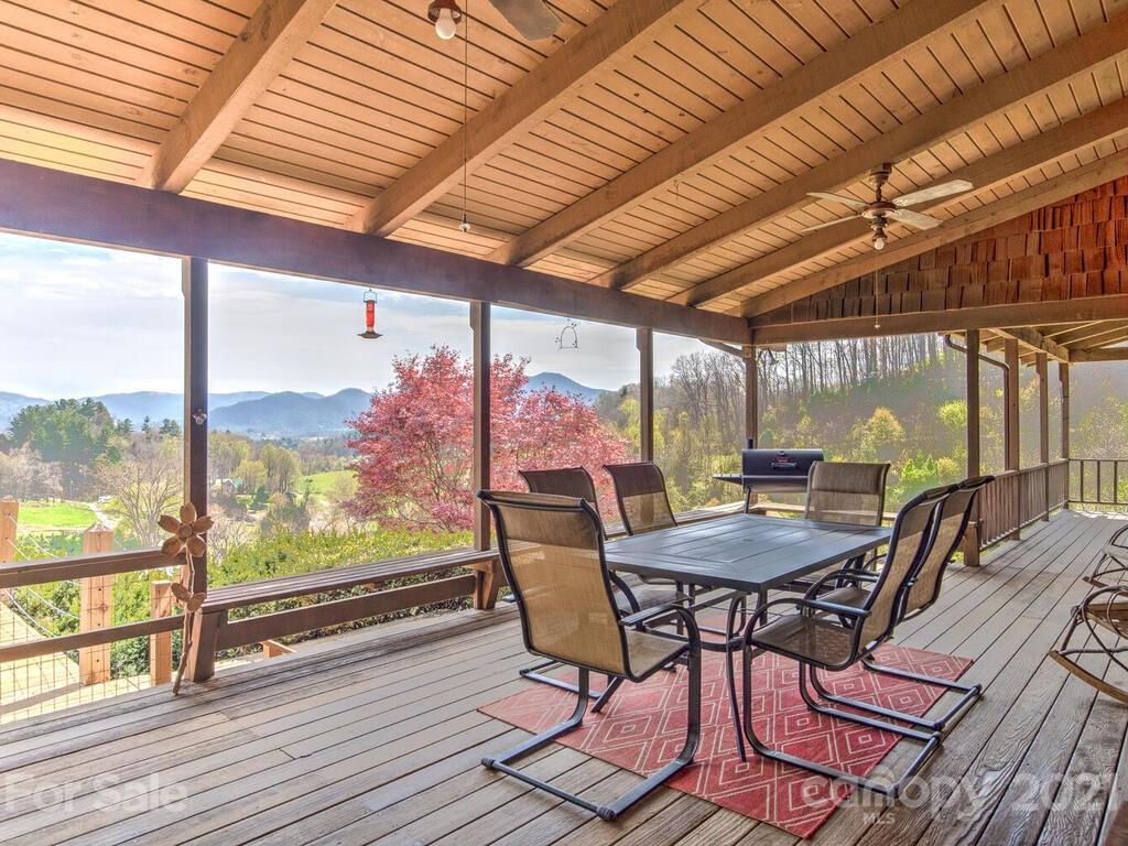 251 Riding High Road Waynesville, NC 28785 - Photo 16 of 41 a view of a porch with furniture and wooden floor