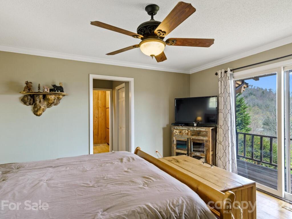 251 Riding High Road Waynesville, NC 28785 - Photo 18 of 41 a bedroom with a bed and a flat screen tv