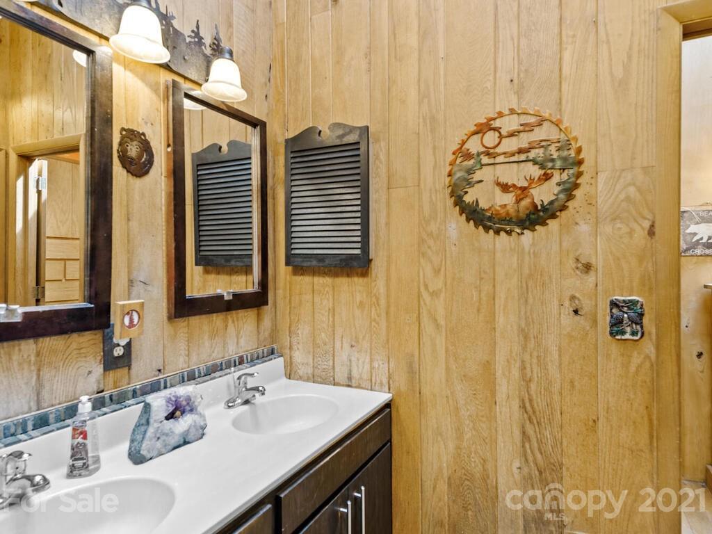 251 Riding High Road Waynesville, NC 28785 - Photo 19 of 41 a bathroom with a sink and a mirror