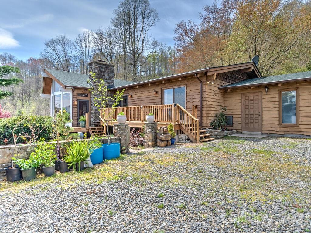 251 Riding High Road Waynesville, NC 28785 - Photo 3 of 41 a view of a house with a yard and sitting area