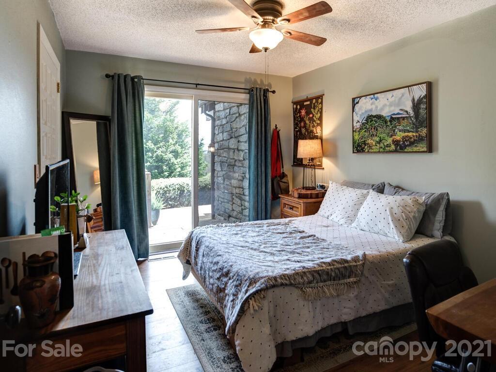 251 Riding High Road Waynesville, NC 28785 - Photo 21 of 41 a bed sitting in a bedroom next to a window