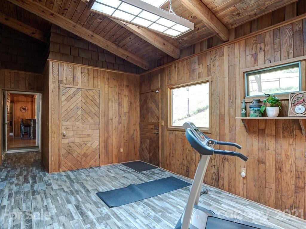 251 Riding High Road Waynesville, NC 28785 - Photo 25 of 41 a view of a bedroom with furniture and wooden floor