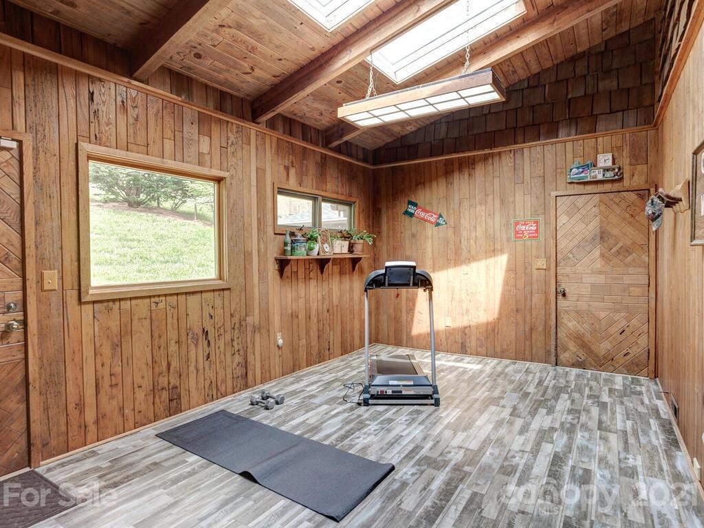251 Riding High Road Waynesville, NC 28785 - Photo 26 of 41 a view of a room with wooden floor and a window