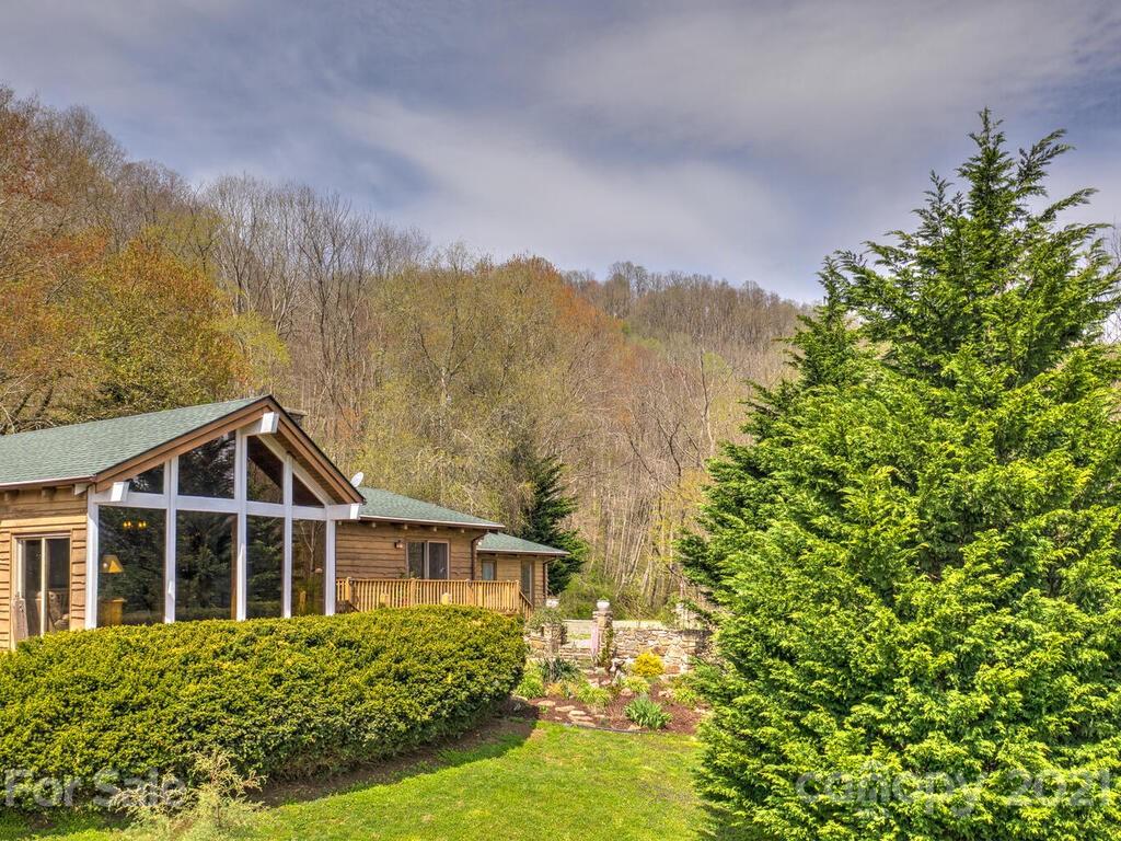 251 Riding High Road Waynesville, NC 28785 - Photo 4 of 41 a view of a big yard with plants and large trees