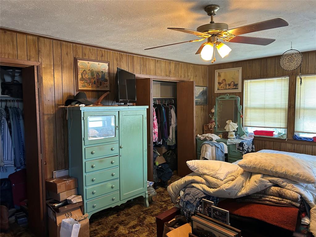 138 Choctaw Trail Whitney, TX 76692 - Photo 11 of 14 a bedroom with a bed and a chandelier