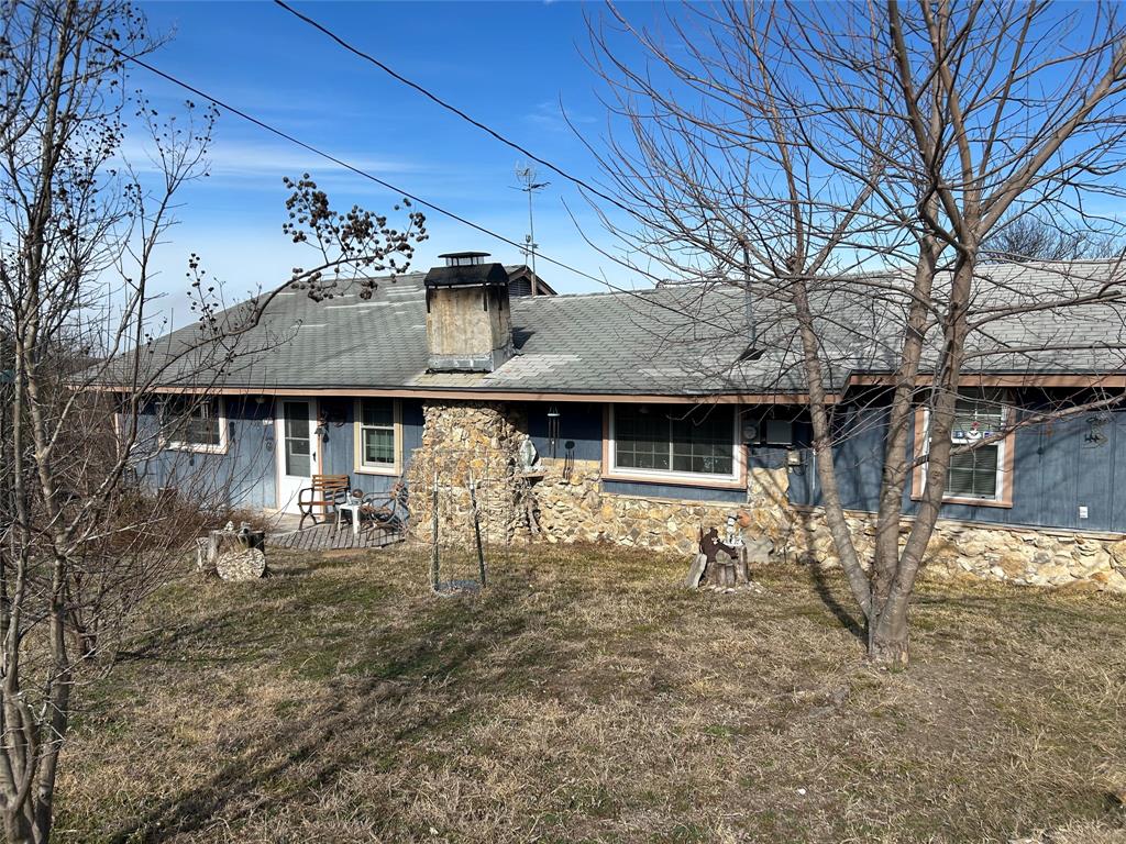 138 Choctaw Trail Whitney, TX 76692 - Photo 2 of 14 a front view of a house with garden