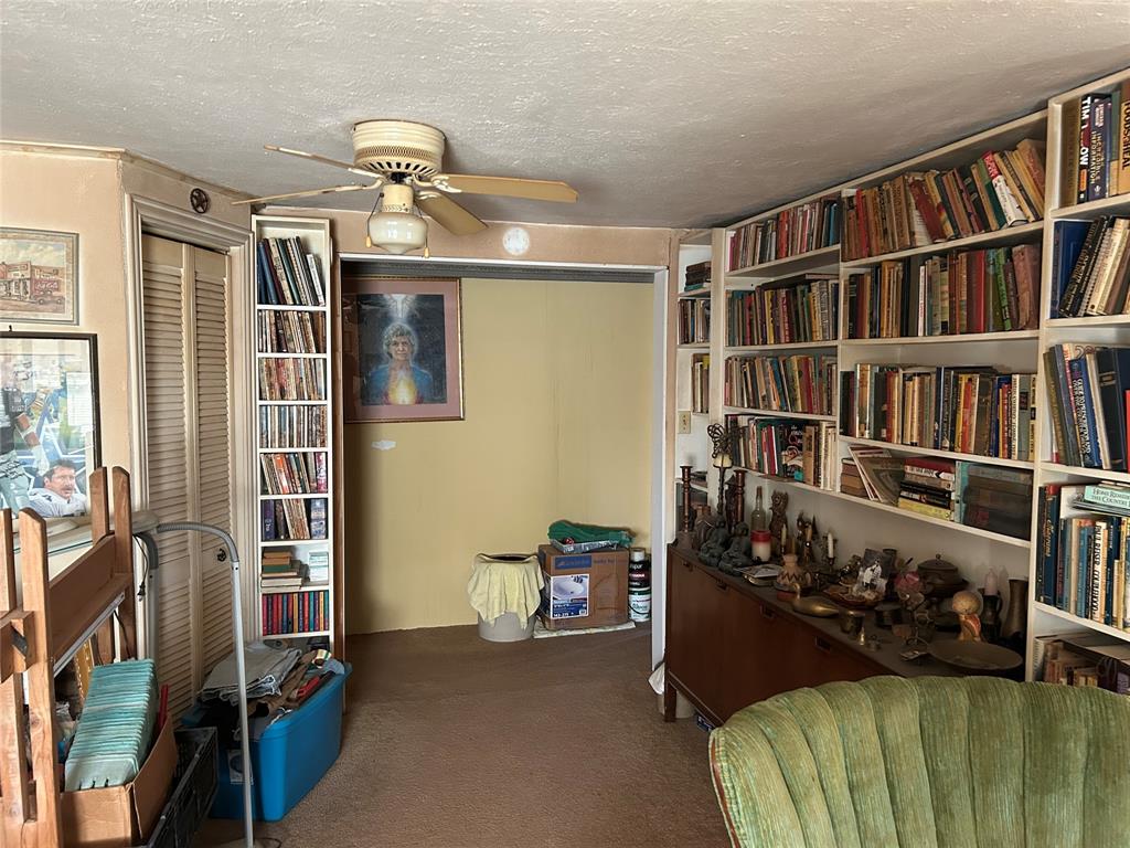 138 Choctaw Trail Whitney, TX 76692 - Photo 7 of 14 a living room with furniture a bookshelf and a window