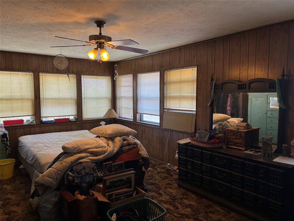 138 Choctaw Trail Whitney, TX 76692 - Photo 10 of 14 a bedroom with a bed and a chandelier