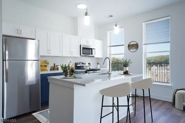 a kitchen with refrigerator cabinets and windows