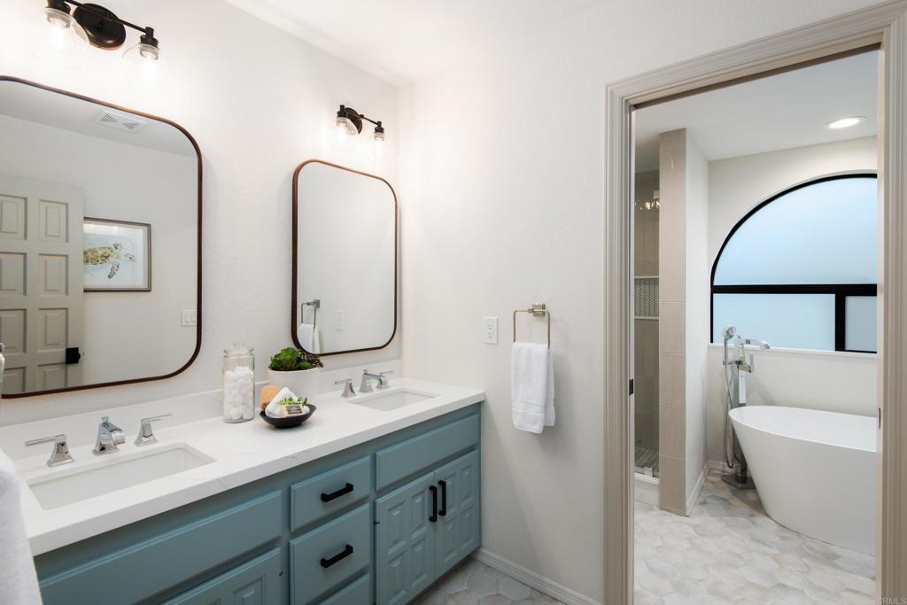 17544 Los Morros Rancho Santa Fe, CA 92067 - Photo 42 of 67 a bathroom with a double vanity sink mirror and bathtub