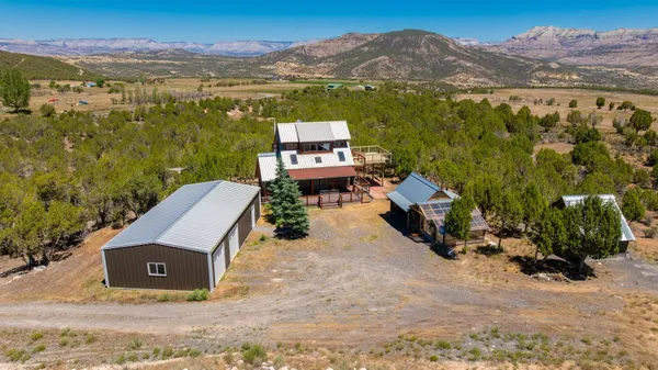 an aerial view of a house with a yard