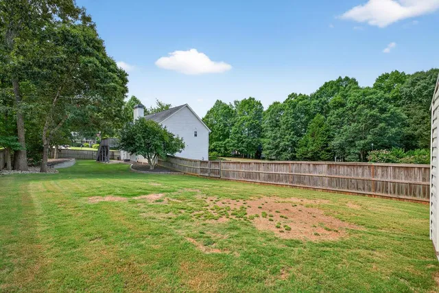 a view of a swimming pool with a yard