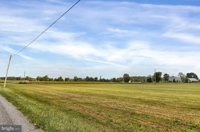 view of a field with an ocean