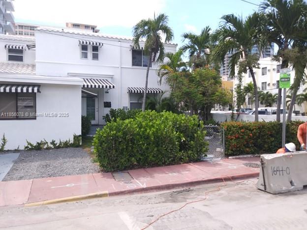 Mid Beach Miami Beach, FL 33140 - Photo 2 of 3 a front view of a house with a garden