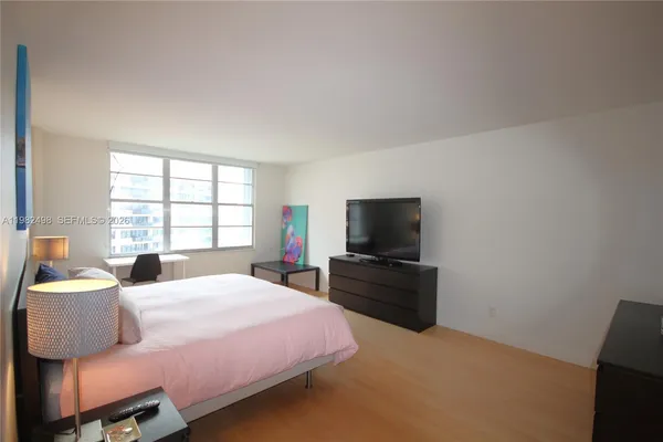 a bedroom with a bed and a television
