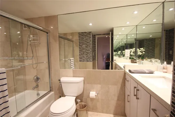 a bathroom with a shower sink and mirror