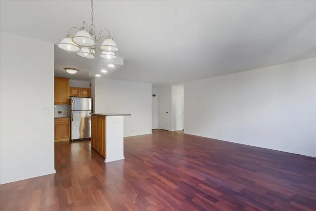 a view of a kitchen with a microwave and wooden floor