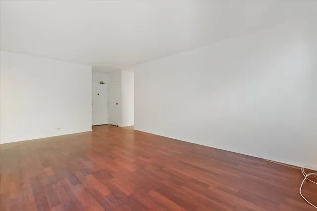 a view of an empty room and wooden floor