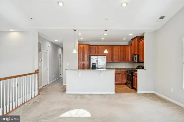 a view of kitchen with refrigerator and window