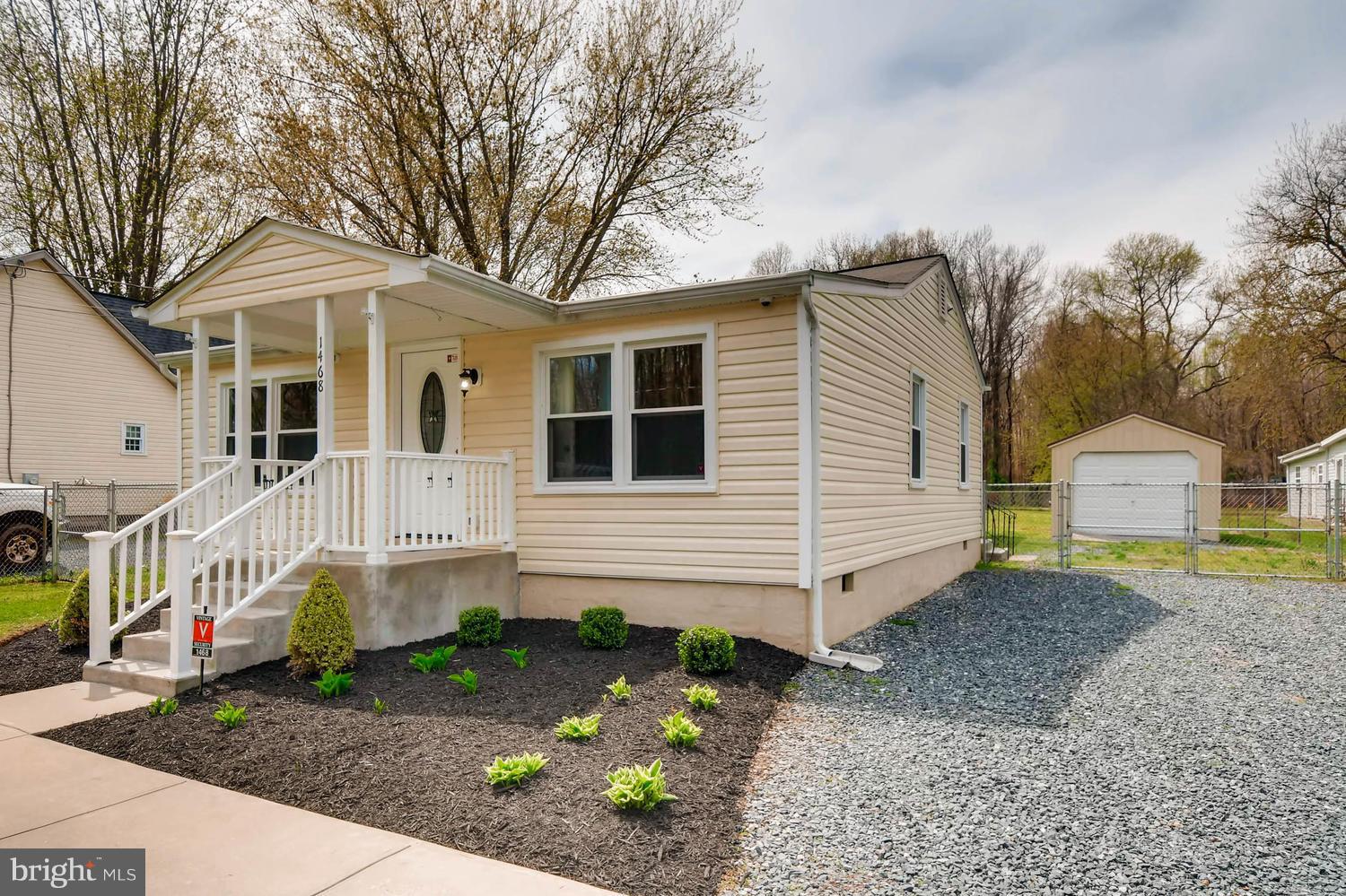 1468 Log Inn Road Annapolis, MD 21409 - Photo 2 of 28 a view of a white house with large windows and a small yard