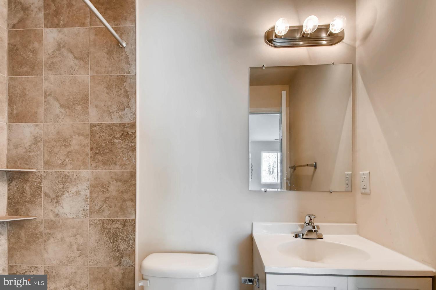 1468 Log Inn Road Annapolis, MD 21409 - Photo 14 of 28 a bathroom with a sink a toilet and a mirror