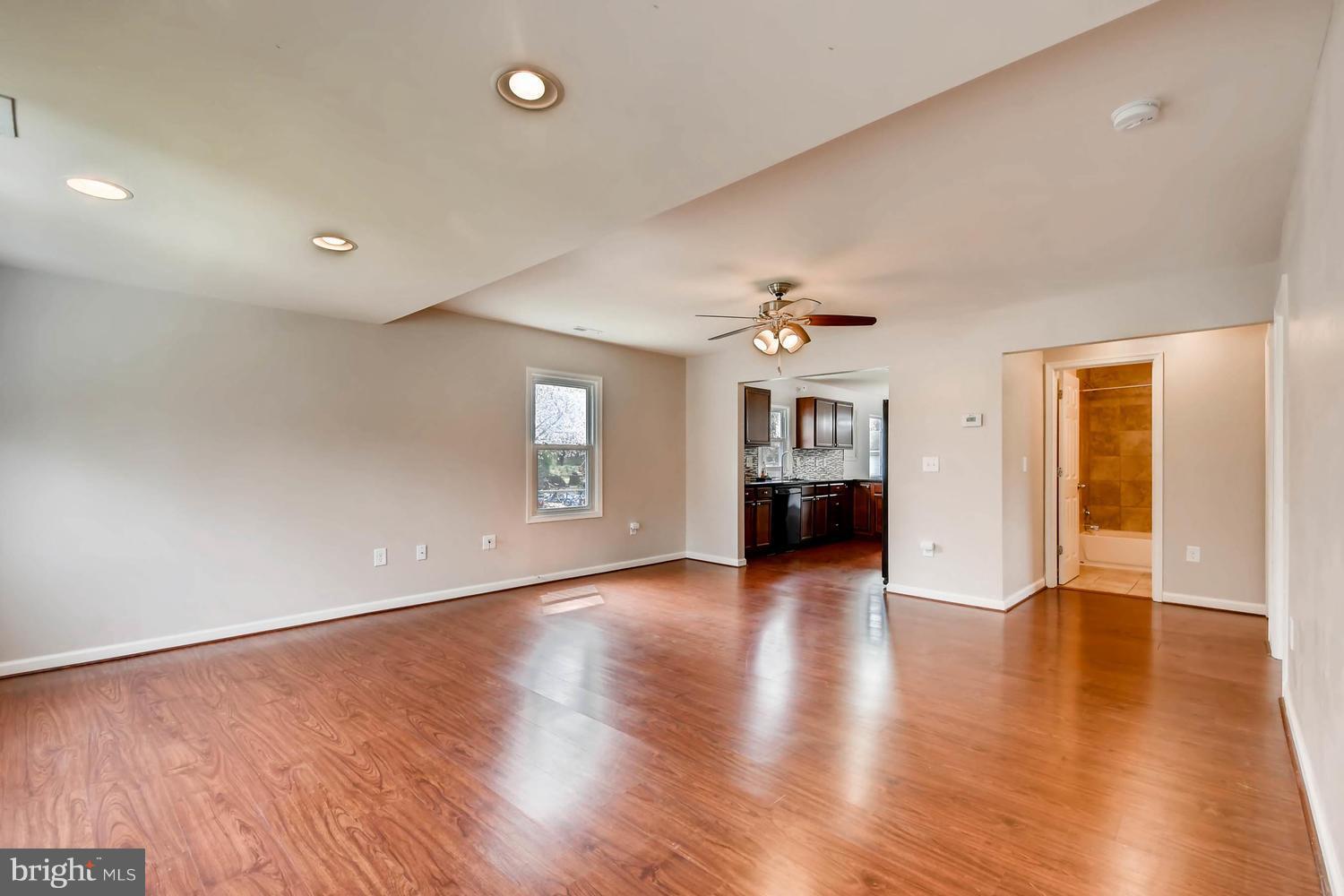1468 Log Inn Road Annapolis, MD 21409 - Photo 3 of 28 an empty room with wooden floor chandelier and windows