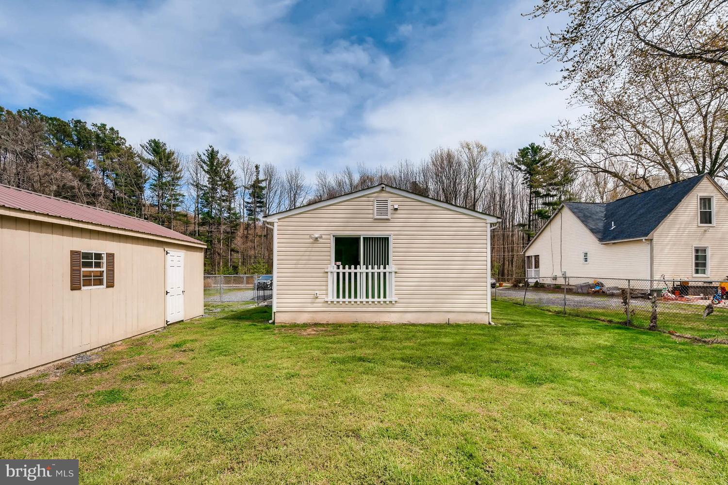 1468 Log Inn Road Annapolis, MD 21409 - Photo 21 of 28 a backyard of a house with table and chairs