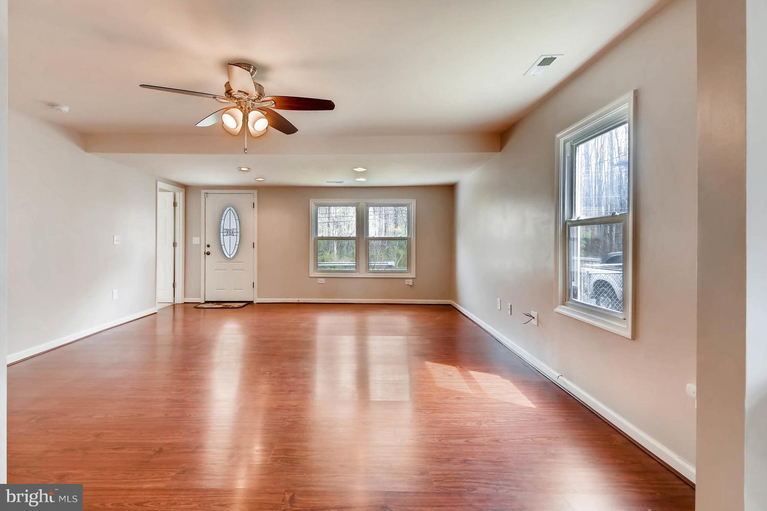 1468 Log Inn Road Annapolis, MD 21409 - Photo 5 of 28 a view of an empty room with wooden floor and window
