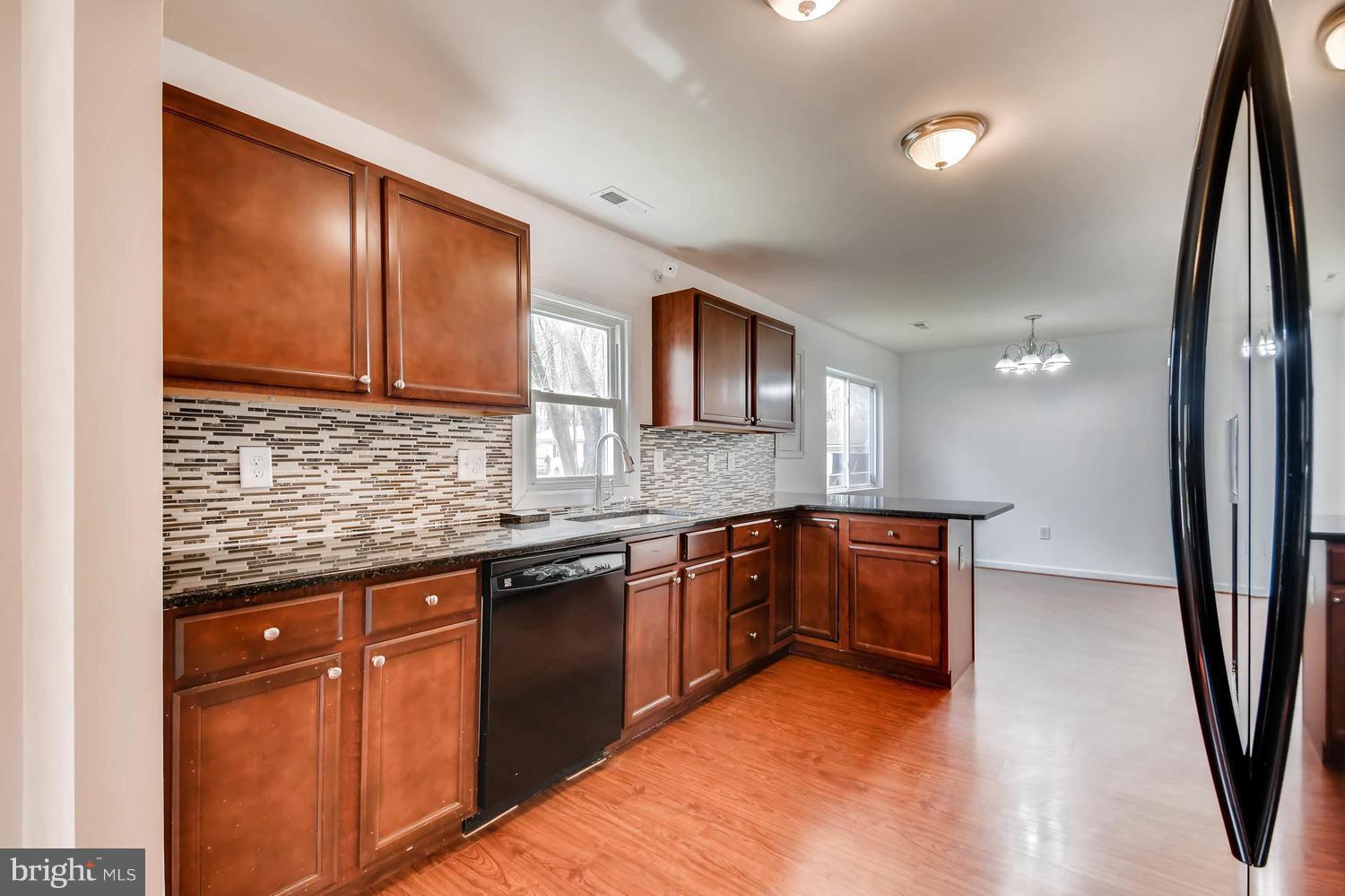 1468 Log Inn Road Annapolis, MD 21409 - Photo 7 of 28 a kitchen with granite countertop a sink stove and cabinets