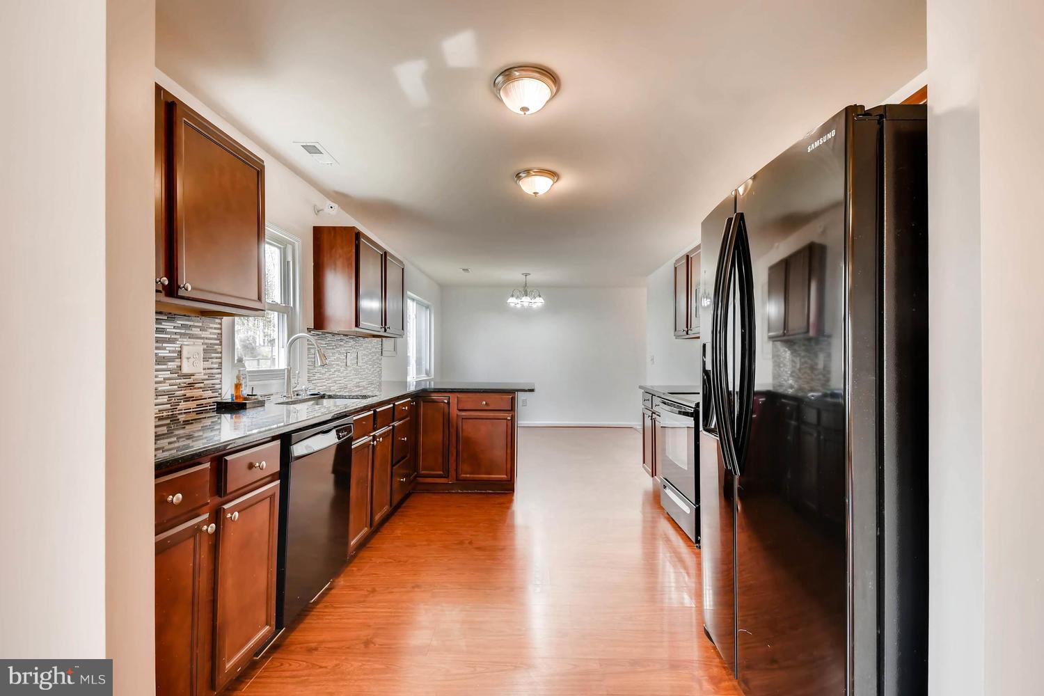 1468 Log Inn Road Annapolis, MD 21409 - Photo 8 of 28 a large kitchen with stainless steel appliances granite countertop a refrigerator and a sink
