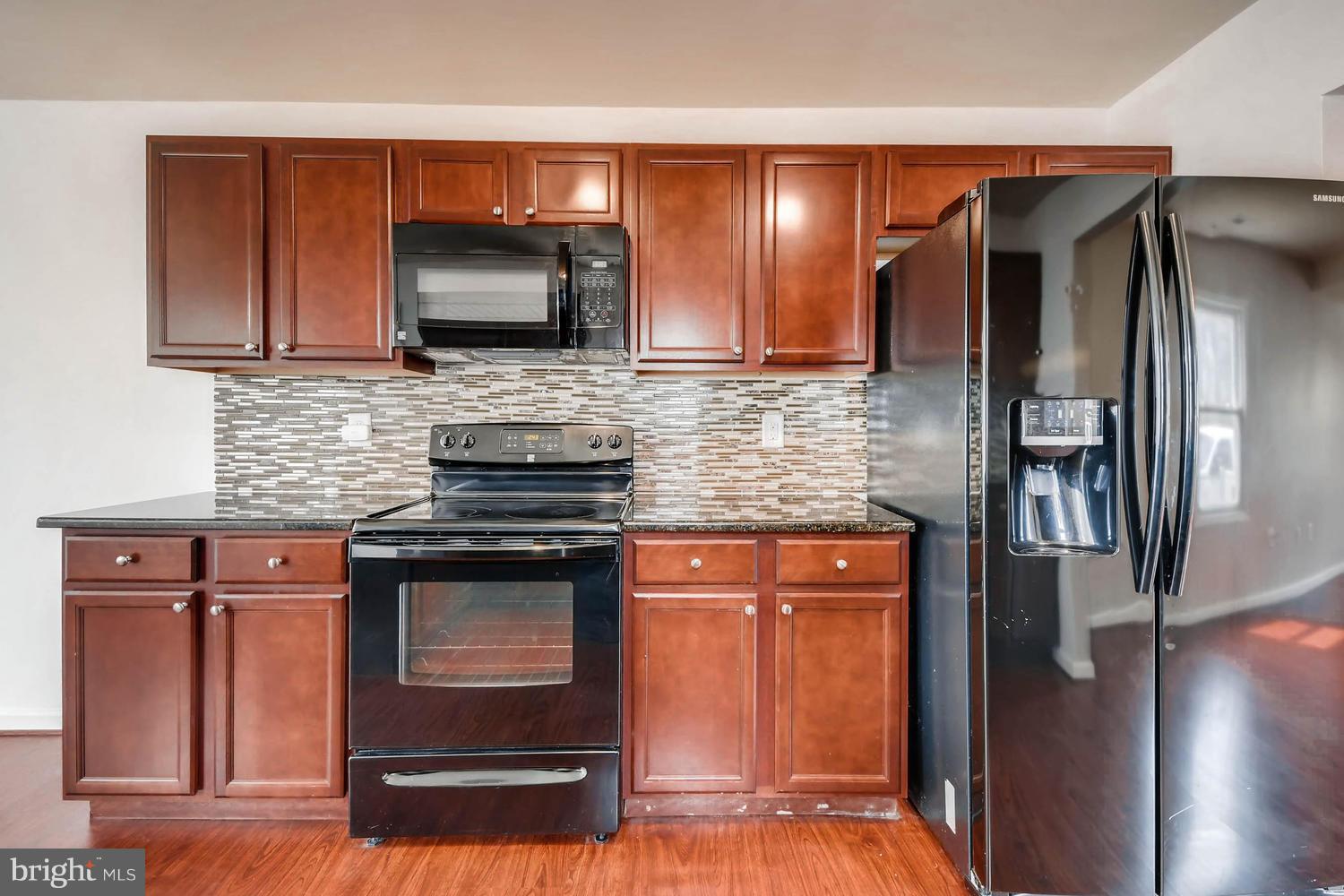1468 Log Inn Road Annapolis, MD 21409 - Photo 9 of 28 a kitchen with stainless steel appliances granite countertop a stove microwave and refrigerator