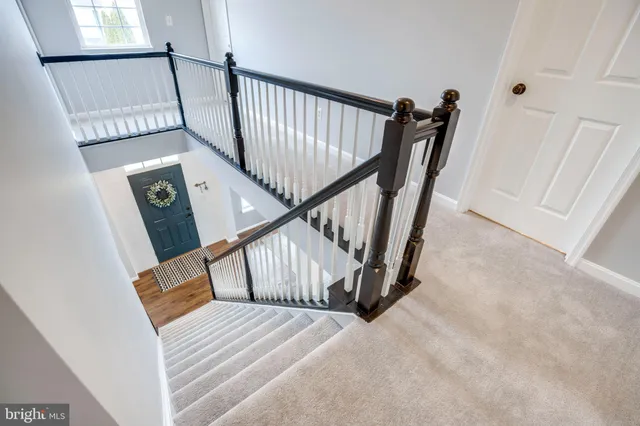a kitchen with stainless steel appliances granite countertop a refrigerator and white cabinets