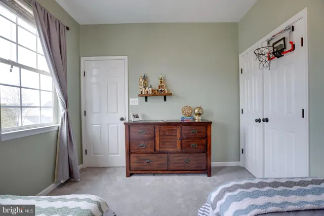 a bedroom with two beds and painted walls