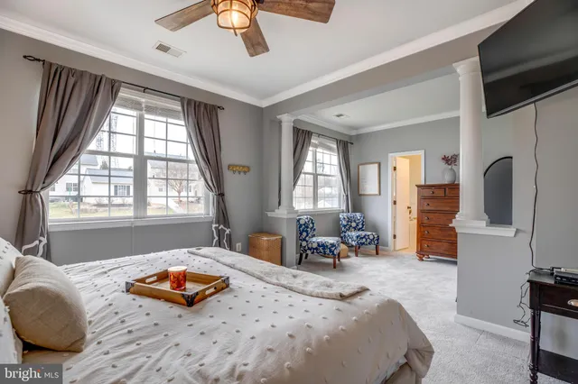 a bedroom with furniture and a flat screen tv