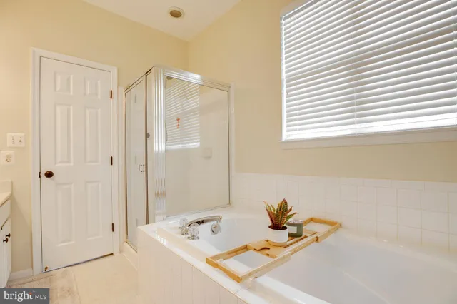 a bathroom with a double vanity sink toilet and a mirror
