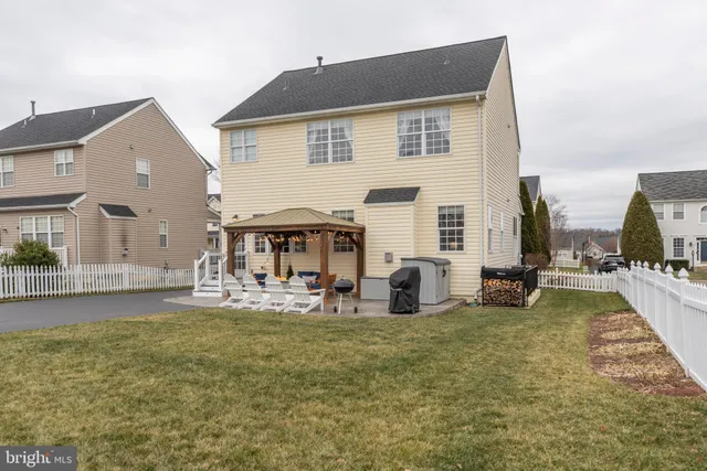a view of a house with backyard porch and sitting area