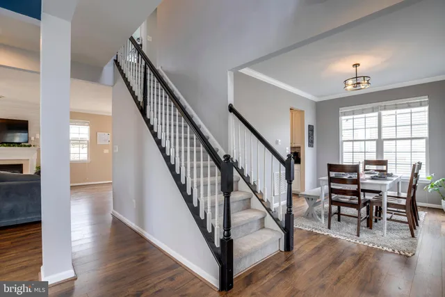 a view of entryway and dining room and wooden floor
