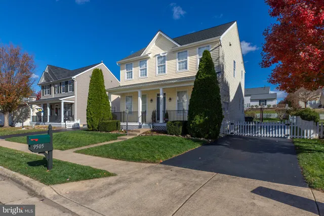 a view of a house with a yard and garden