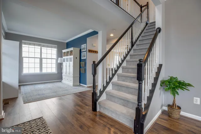 a view of entryway and hall with wooden floor