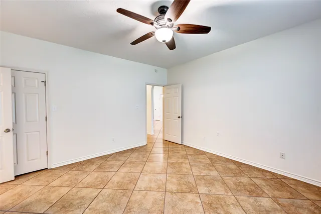 a view of a hallway with a furniture and a bathroom