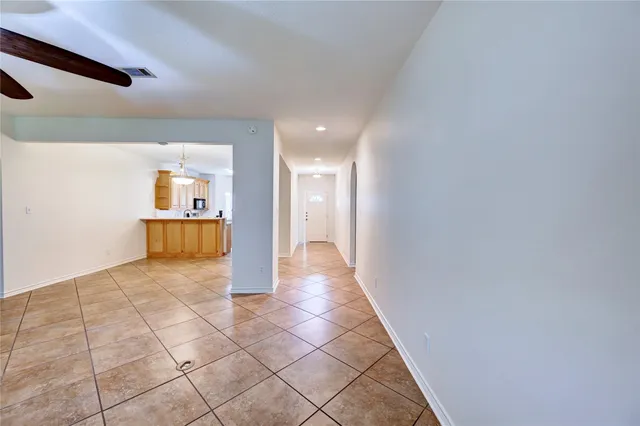 a view of a hallway view with wooden floor and a bathroom